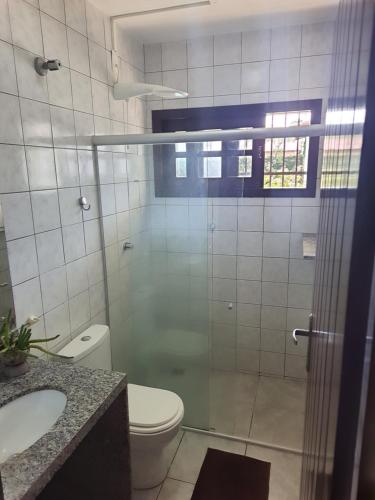a bathroom with a shower and a toilet and a sink at Hostel Atairú in Natal