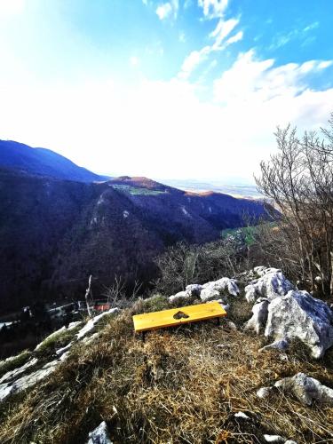 a yellow bench sitting on top of a mountain at Riverside Guesthouse in Ig