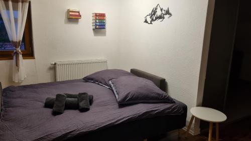 a bed with two stuffed animals on it at Ferienwohnung Bergfreunde inkl Chiemgaukarte in Bergen