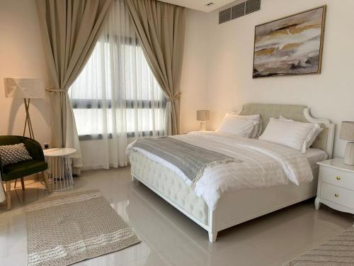 a bedroom with a large white bed and a window at Ocean pearl in Sharm
