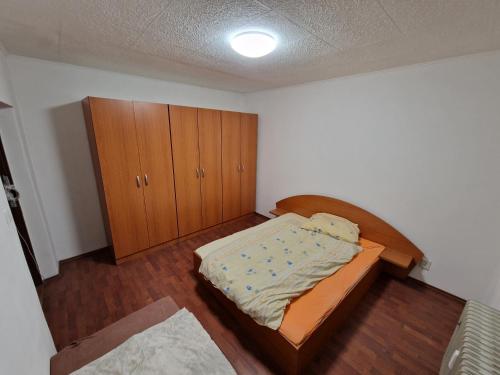 a small bedroom with a bed and a cabinet at Sankt Martin Hostel in Martin