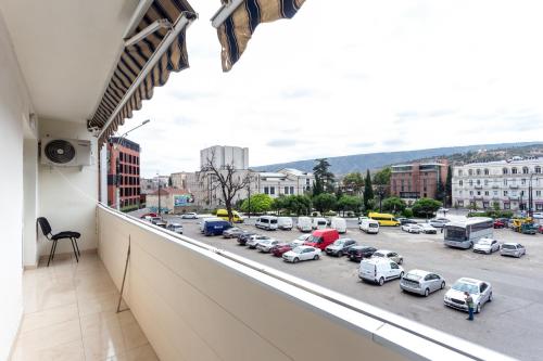 a balcony with a view of a parking lot at Prime location Apartment with Three Bedroom in Tbilisi City