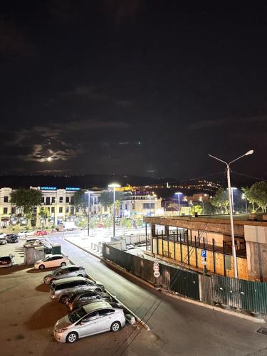 a row of cars parked in a parking lot at night at Prime location Apartment with Three Bedroom in Tbilisi City