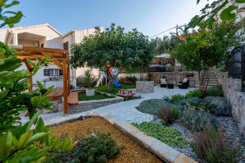 a backyard with a garden with a stone walkway at Home with a unique view in Preko