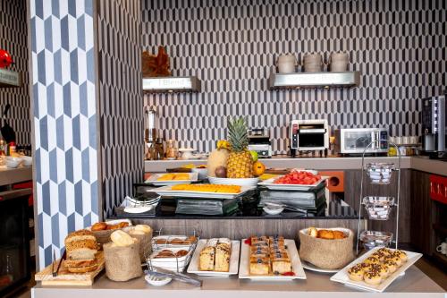 a buffet with many different types of food on a counter at Hampton By Hilton Lima San Isidro in Lima