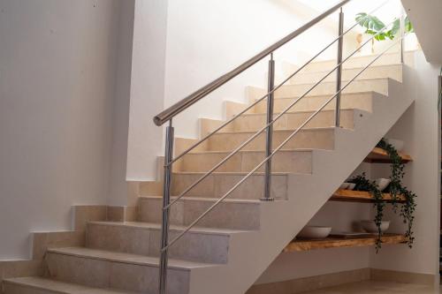 a staircase with metal railings in a house at New Beachfront Penthouse Punta Popy in Las Terrenas