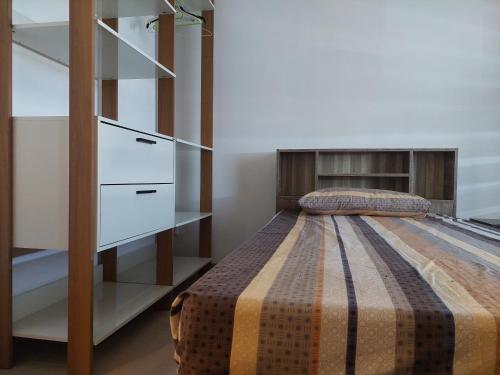 een slaapkamer met een bed en een dressoir bij 17 Coral Terrace Apartments in Flic-en-Flac