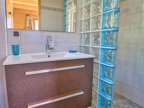 a bathroom with a sink and a glass wall at Chalet typique, 4 chambres, vue montagne, WIFI, parking - FR-1-505-66 in Notre-Dame-de-Bellecombe