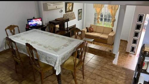 a living room with a table and chairs and a couch at Emy in Oberá