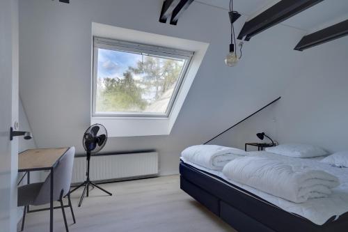 a bedroom with a bed and a window and a desk at 9 Rooms Amazing Sommerhouse in Børkop