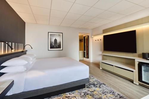 a bedroom with a white bed and a flat screen tv at Hyatt Regency Chicago in Chicago