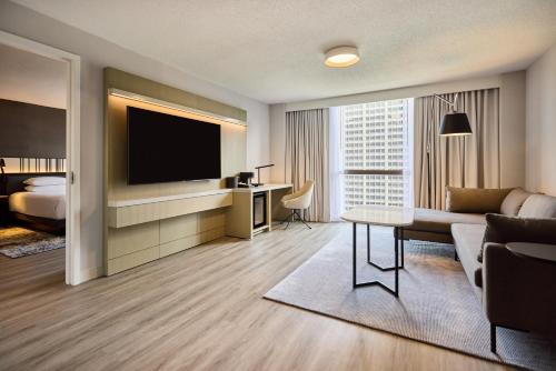 a hotel room with a couch and a television at Hyatt Regency Chicago in Chicago