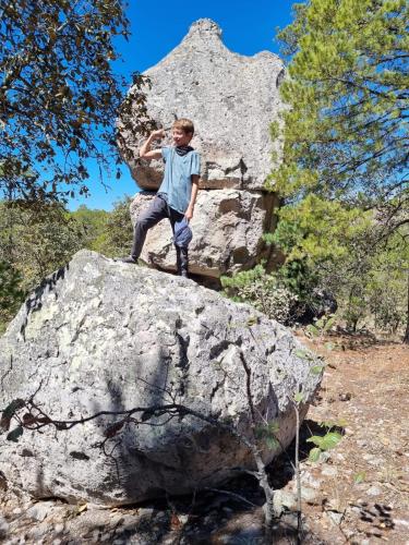 a young boy sitting on top of a rock at Glamping Town in Otinapa