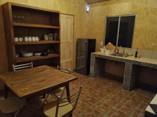 a kitchen with a table and a counter and a refrigerator at Glamping Town in Otinapa