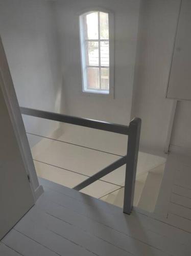 a bench in a white room with a window at Ferienhaus Bieberhöhe in Plön