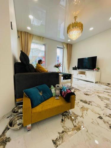 a living room with a couch and a damaged floor at Baltijos apartamentai in Klaipėda