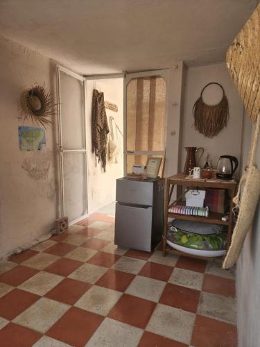 a kitchen with a checkered floor and a refrigerator at The Suite. Few steps & beach! in Chelem