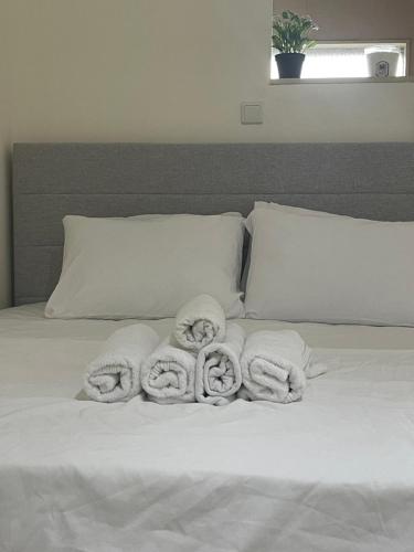 a white bed with towels on top of it at Estrela Mares Haifa in Haifa