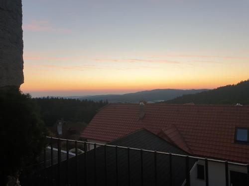 a view of the sunset from the roof of a house at Penzion Zvonice Hojná Voda in Horní Stropnice