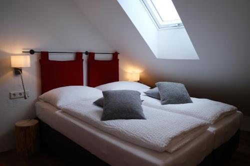 a bedroom with a bed with two pillows on it at Burglodge Fischerkeusche in Mauterndorf