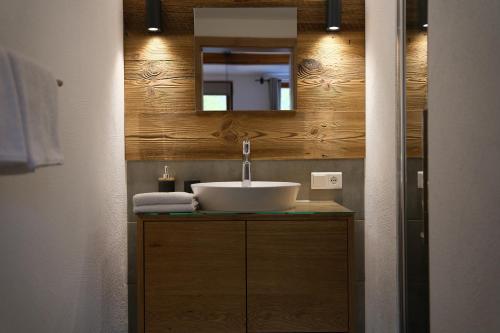 a bathroom with a sink and a mirror at Burglodge Fischerkeusche in Mauterndorf
