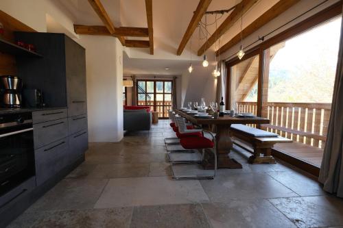 a dining room with a table and a large window at Burglodge Fischerkeusche in Mauterndorf