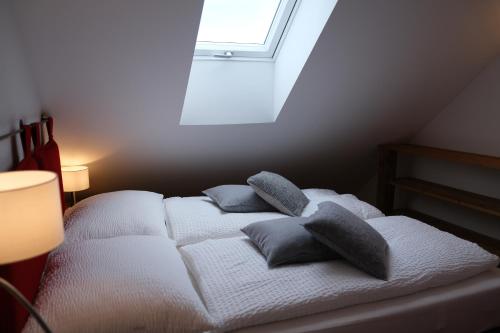 a bedroom with a bed with pillows on it at Burglodge Fischerkeusche in Mauterndorf