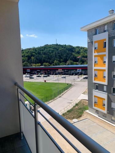a balcony with a view of a parking lot at Apartman Mančić in Pirot