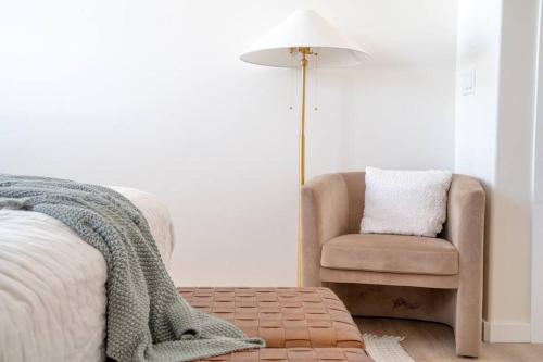 a bedroom with a chair and a pillow and a lamp at Rustic Gold Retreat in Kanab