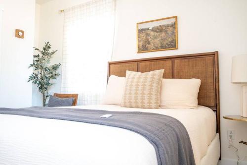 a bedroom with a bed with a wooden headboard at Rustic Gold Retreat in Kanab