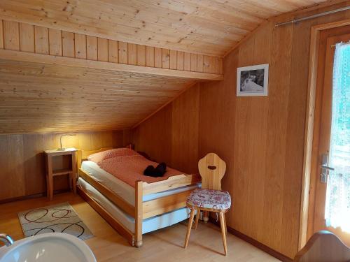 a bedroom with a bed in a wooden room at Chant du Torrent: 12 pers. idéal pour les familles in Nendaz