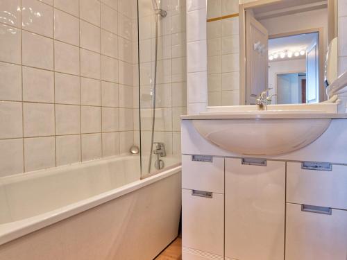 a bathroom with a sink and a tub and a mirror at Appartement Flumet, 3 pièces, 6 personnes - FR-1-505-109 in Flumet