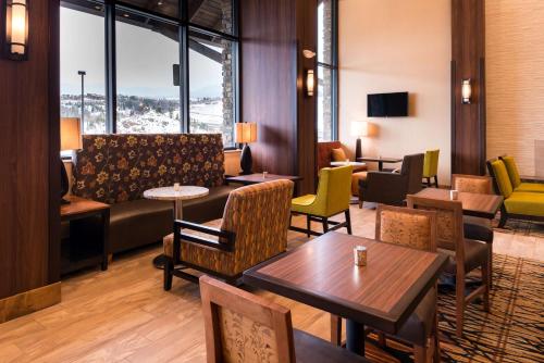 a living room with a couch and tables and chairs at Hampton Inn & Suites Silverthorne in Silverthorne