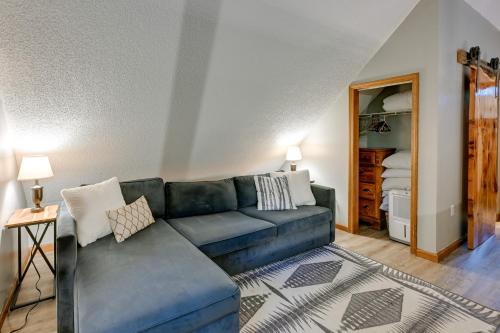 a living room with a blue couch and a bedroom at Sapphire Valley Cabin with Private Mountain Views! in Sapphire