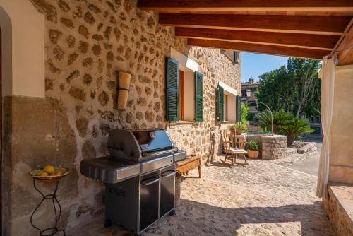 a outdoor kitchen with a smoker and a grill at Sa Finqueta, Luxury Elegant Mansion with breathtaking views of Soller in Sóller