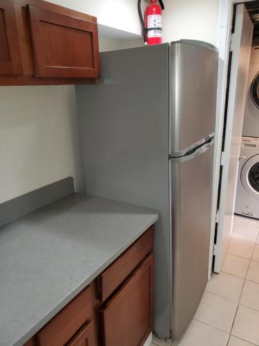 a kitchen with a stainless steel refrigerator at STS - Single Traveler Studio -Black Door in Washington, D.C.