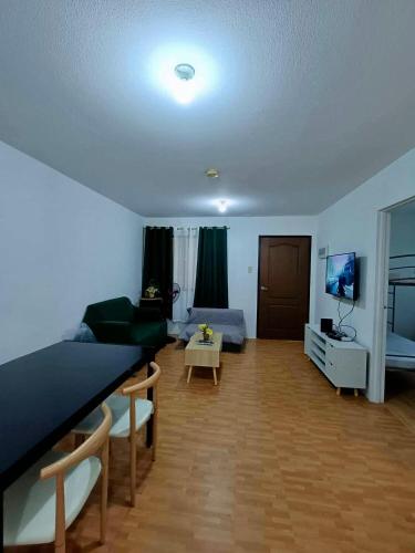 a living room with a bed and a couch at Alles One Oasis Condo Davao Near SM Mall with Wifi in Davao City