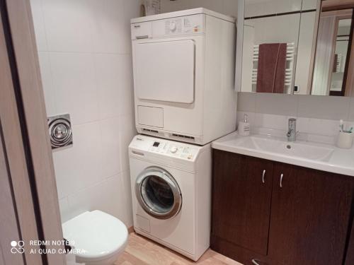 une salle de bain avec une machine à laver et un lavabo dans l'établissement Studio mezzanine 32m² Tignes, balcon, wifi, lave-linge, séjour lit convertible - FR-1-449-184, à Tignes