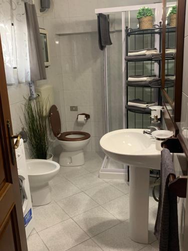 a bathroom with a toilet and a sink at Enjoy in Viareggio