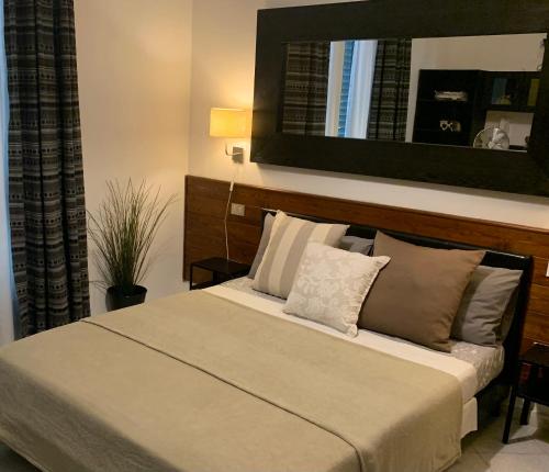 a bedroom with a bed with a headboard and pillows at Enjoy in Viareggio