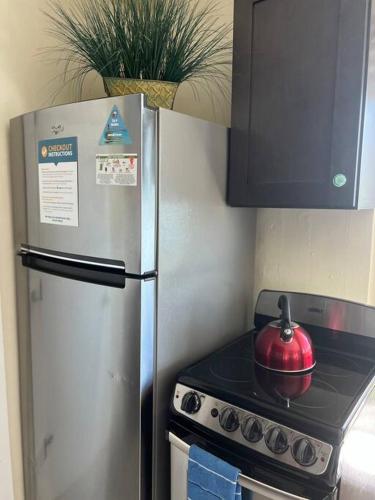 a kitchen with a stainless steel refrigerator and a tea kettle on a stove at Boot Key Harbor Penthouse in Marathon