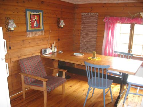 a dining room with a wooden table and chairs at Sogn Gjestegard in Svarstad