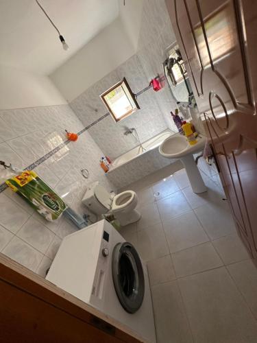 a bathroom with a washing machine and a sink at Villa Anna in Sarandë