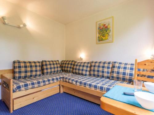 a living room with a couch and a table at Studio Les Arcs 1800, 1 pièce, 2 personnes - FR-1-346-487 in Arc 1800