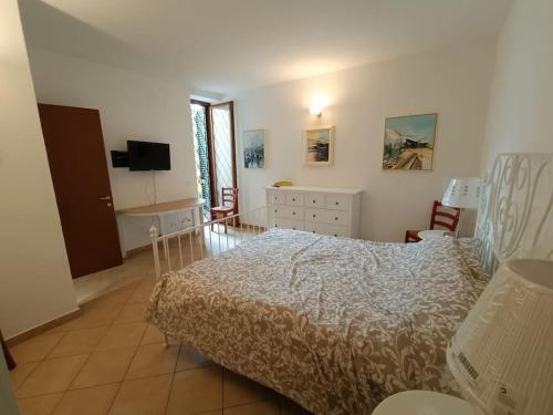 a bedroom with a bed and a desk and a television at Alle Porte del Chianti in Castiglioni