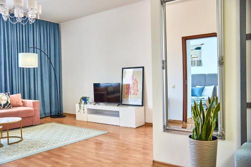 a living room with a tv and a mirror at Wonderful Panoramic View Apartment in Mukacheve