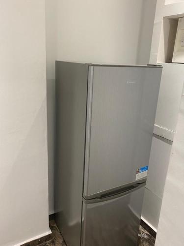 a stainless steel refrigerator sitting in a kitchen at Au Calme in Le Cannet