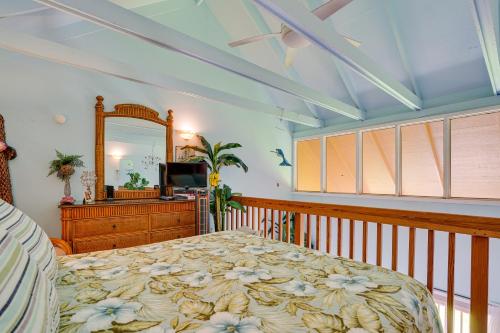 a bedroom with a bed and a mirror at Oceanfront Maunaloa Condo, Steps to Pool and Beach! in Maunaloa