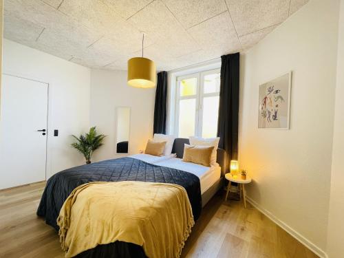 a bedroom with a bed and a window at aday - Frederikshavn apartment on the Pedestrian street in Frederikshavn