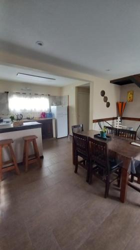 a kitchen and living room with a table and chairs at EL BAGUAL DE MONTE in San Miguel del Monte
